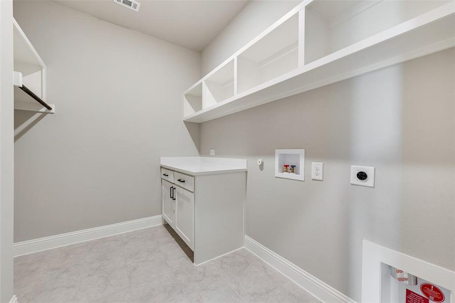 Laundry area featuring gas dryer hookup, hookup for an electric dryer, and washer hookup