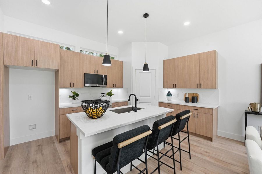 The kitchen features quartz counters and farm house sink.