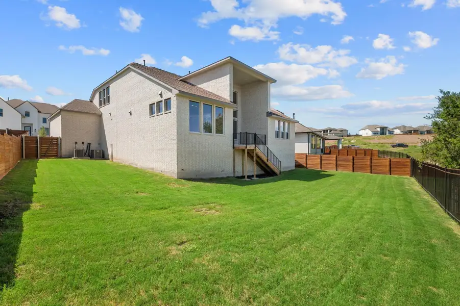 Front exterior of a new home in Provence - 60', Austin, TX, highlighting curb appeal (Image 2). Front exterior of a new home in Provence - 60', Austin, TX, highlighting curb appeal (Image 2).