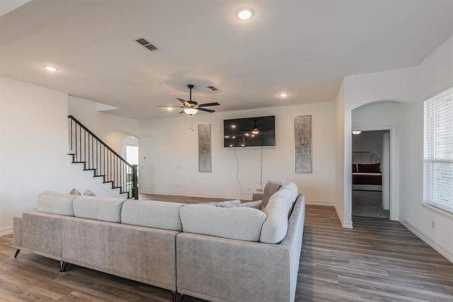 Living room with ceiling fan and wood-type flooring