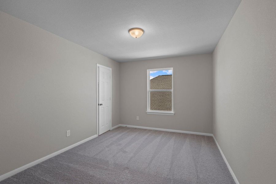 Your secondary bedroom features plush carpet, fresh paint, closet, and a large window that lets in plenty of natural lighting.