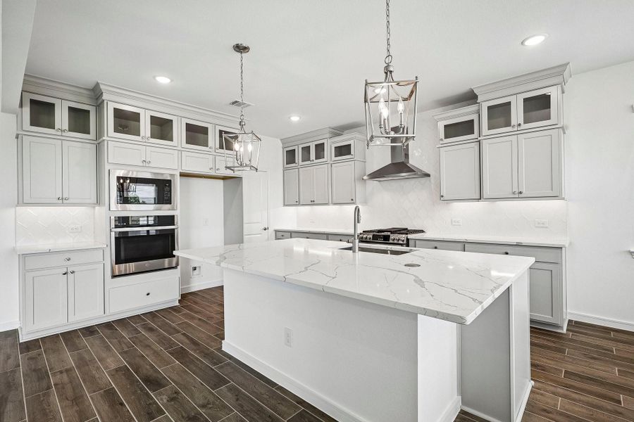 Stylish kitchen with light grey stacked cabinets and quartz counters Stylish kitchen with light grey stacked cabinets and quartz counters