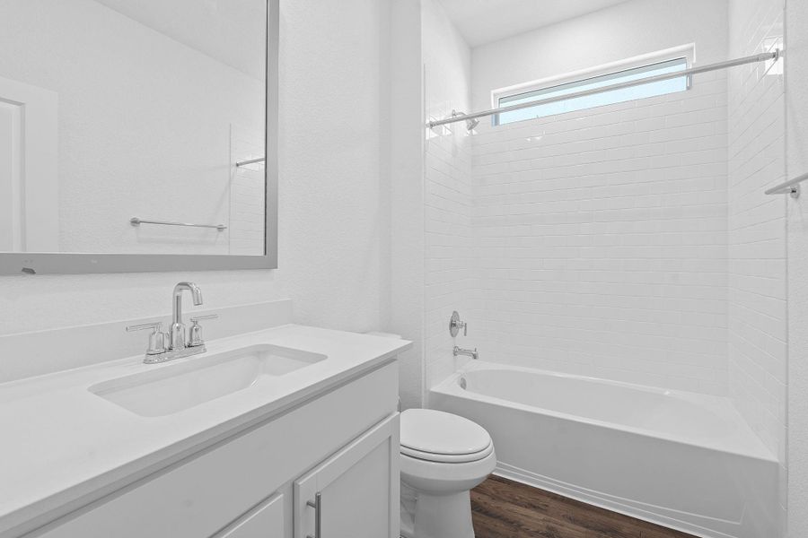 Full bath featuring bathing tub / shower combination, dark wood finished floors, and vanity Full bath featuring bathing tub / shower combination, dark wood finished floors, and vanity