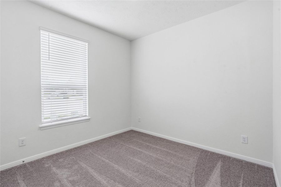 Tucked peacefully in the front of the home is this secondary bedroom! It offers comfort and style with plush carpeting, neutral paint tones, recessed lighting, a large window with blinds, and an ample sized closet. Tucked peacefully in the front of the home is this secondary bedroom! It offers comfort and style with plush carpeting, neutral paint tones, recessed lighting, a large window with blinds, and an ample sized closet.