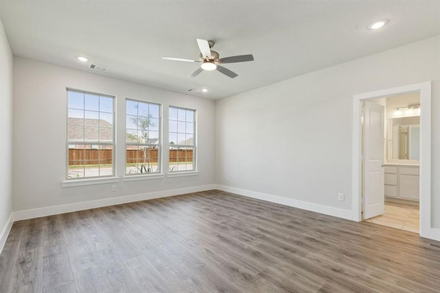 Unfurnished room featuring ceiling fan and dark wood-type flooring