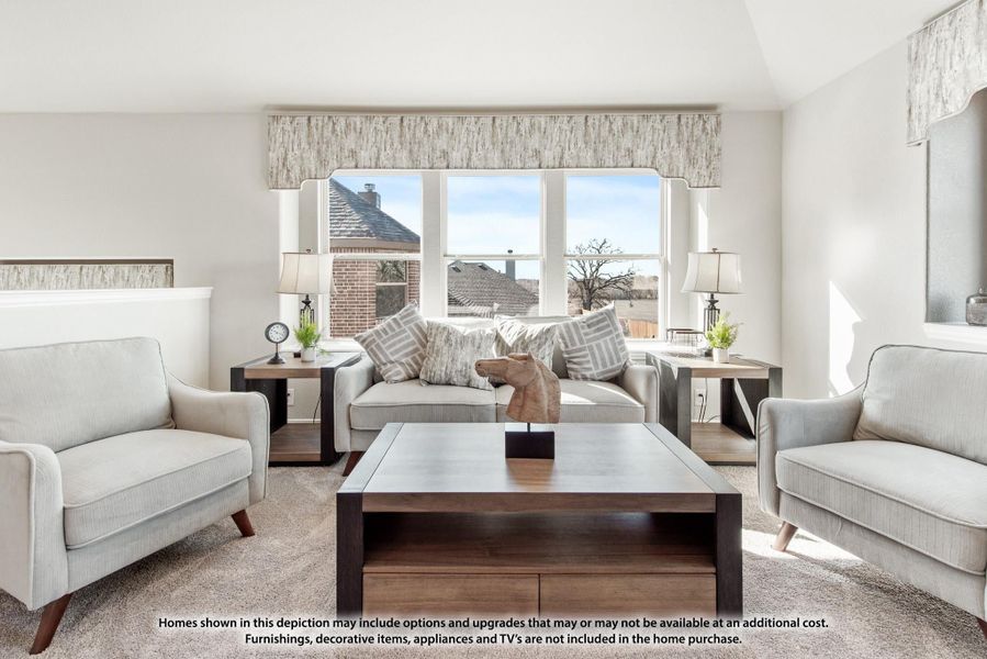 Bright living room with neutral sofa, two armchairs, wood coffee table, and large windows with neighborhood view.