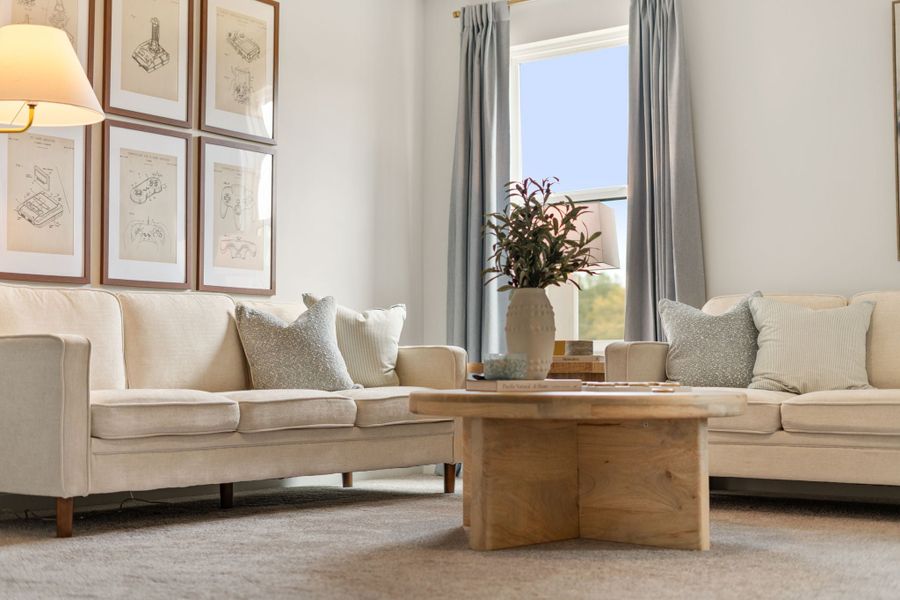 A living room with a couch and a coffee table. A living room with a couch and a coffee table.