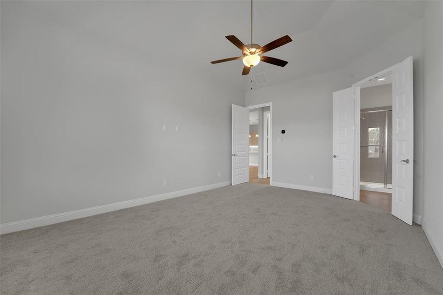 Unfurnished bedroom featuring light carpet and a ceiling fan