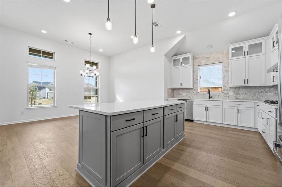 Central kitchen island with gray cabinetry and white countertop