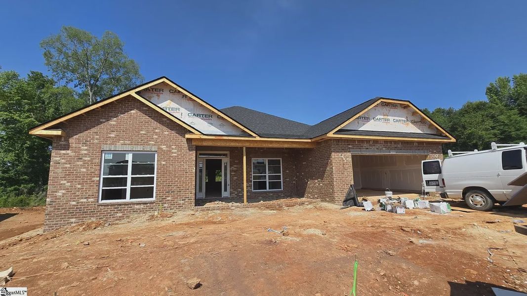 Front exterior of a new home in Hidden Lake Estates, Greenville, SC, highlighting curb appeal (Image 1).