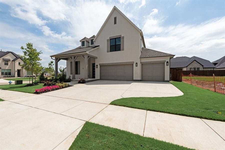 Front exterior of a new home in Estates at Rockhill, Frisco, TX, highlighting curb appeal (Image 22). Front exterior of a new home in Estates at Rockhill, Frisco, TX, highlighting curb appeal (Image 22).