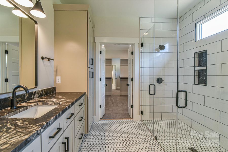 Primary bathroom with walk-in shower. Similar photo.