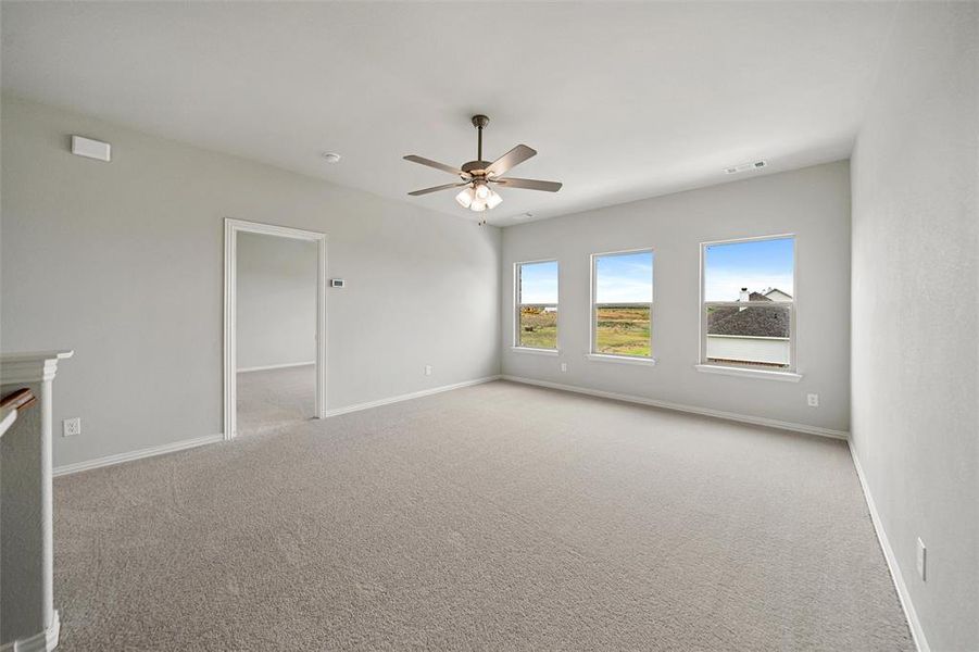 Spare room with light colored carpet and ceiling fan Spare room with light colored carpet and ceiling fan