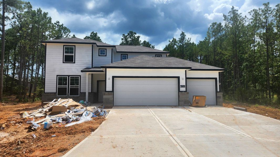 Front exterior of a new home in Oakwood Ranch, Willis, TX, highlighting curb appeal (Image 2). Front exterior of a new home in Oakwood Ranch, Willis, TX, highlighting curb appeal (Image 2).