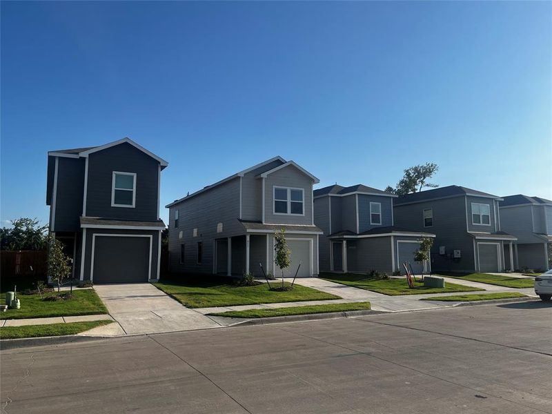 Newly constructed two-story residence featuring a contemporary exterior in a muted color palette Newly constructed two-story residence featuring a contemporary exterior in a muted color palette