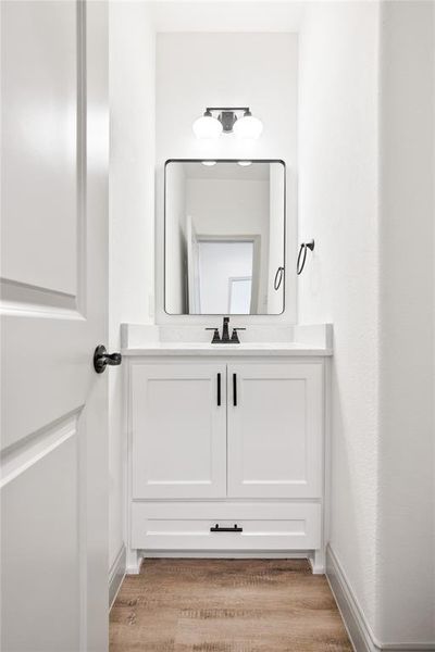 Bathroom featuring vanity and light wood finished floors