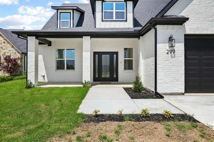 Modern farmhouse-style exterior featuring white brick siding and dark trim Modern farmhouse-style exterior featuring white brick siding and dark trim