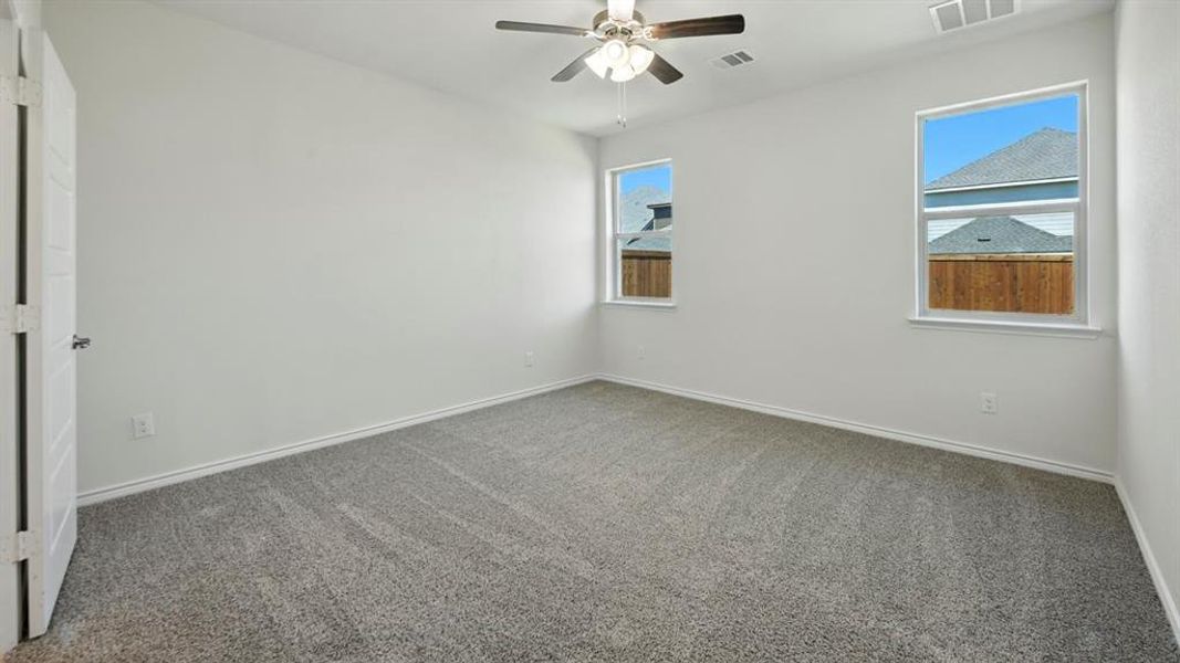 Spare room with carpet flooring and a ceiling fan