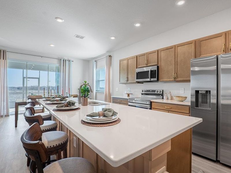 Meals are a delight in your beautiful kitchen with seating at the island and adjacent sunny dining cafe - Monroe by Highland Homes