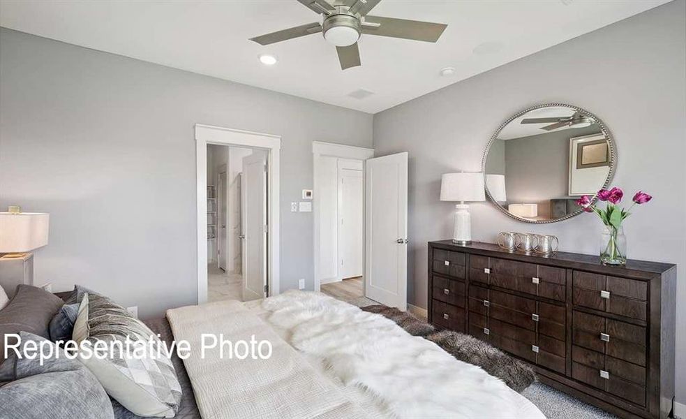 This room features light grey walls and a ceiling fan with integrated lighting