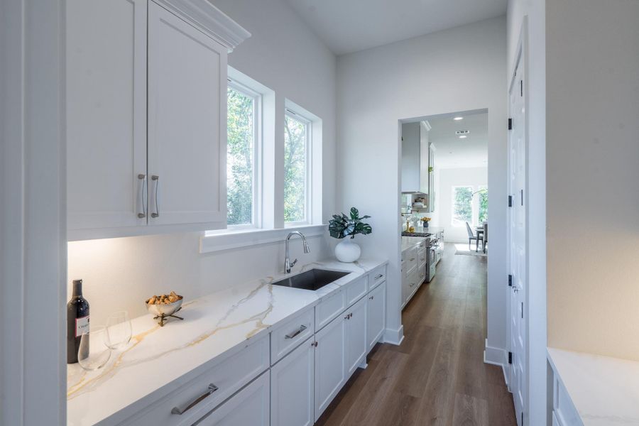 Bright, modern butler’s pantry with under-cabinet lighting and beautiful warm vinyl floors. Bright, modern butler’s pantry with under-cabinet lighting and beautiful warm vinyl floors.