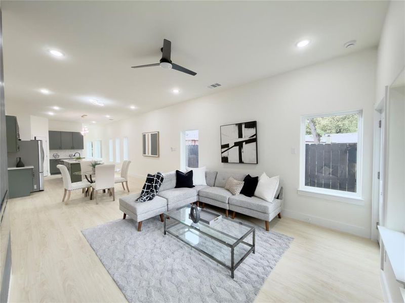 Living area featuring light wood finished floors, recessed lighting, and a ceiling fan