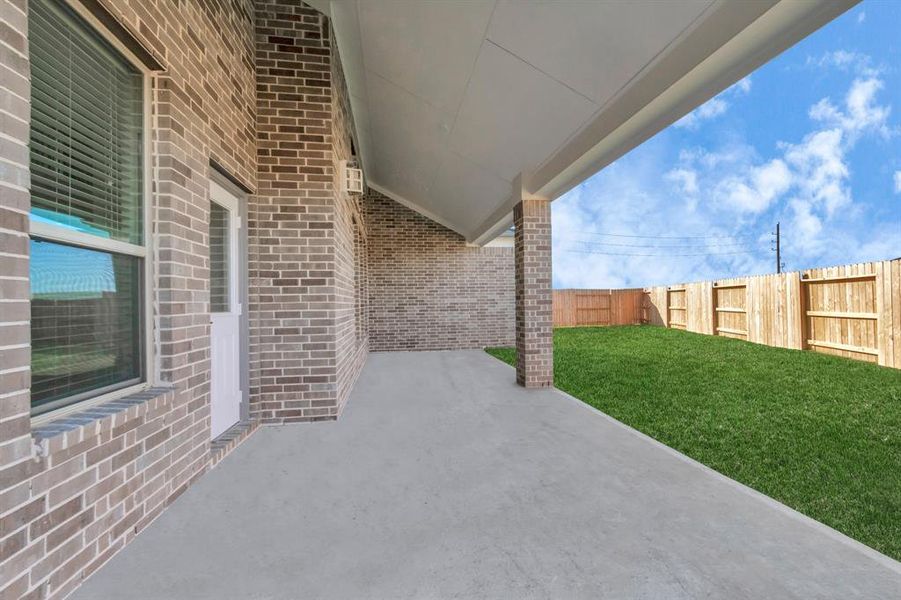 Step into a world of outdoor possibilities in this expansive backyard oasis. A covered patio beckons for relaxation, while the large yard provides ample space for kids to play. Ideal for hosting large barbecue gatherings and outdoor games, this space is a haven for family and friends to enjoy. Sample photo of completed home with similar floor plan. As-built interior colors and selections may vary.