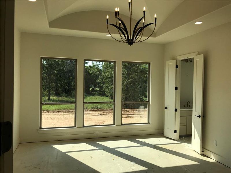 Unfurnished dining area featuring recessed lighting, concrete floors, lofted ceiling, and a chandelier