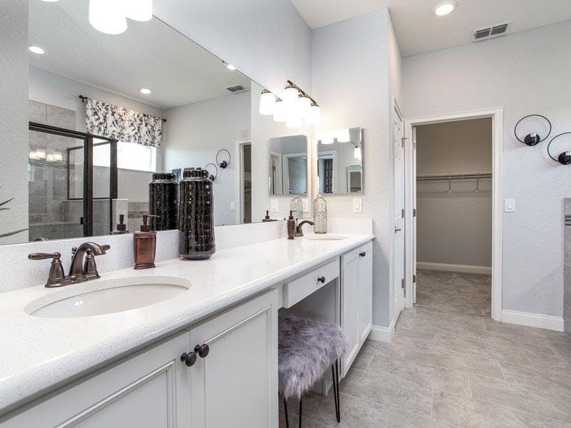 Luxurious en-suite owner`s bath with garden tub, tiled shower, dual vanities with sitting area, large walk-in wardrobe, and enclosed toilet - Westin ll home plan by Highland Homes