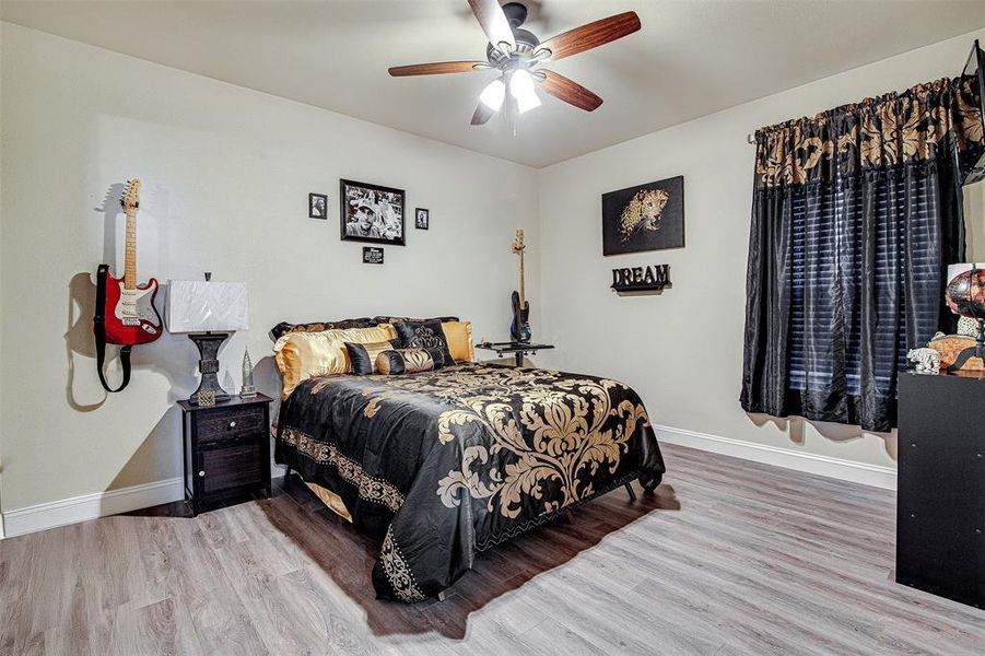 Bedroom featuring wood-type flooring and ceiling fan