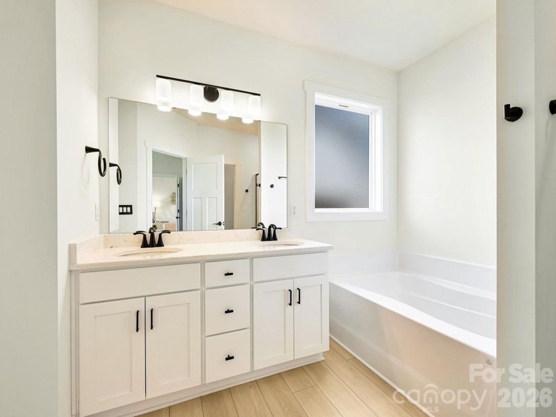 Dual vanity and soaking tub. Privacy window for light.