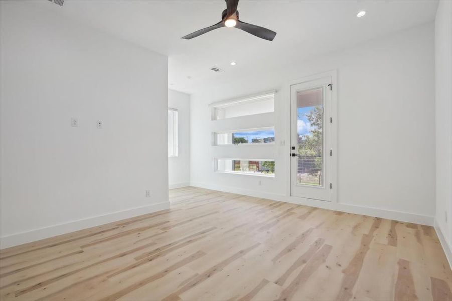 Unfurnished room with light wood-type flooring and ceiling fan