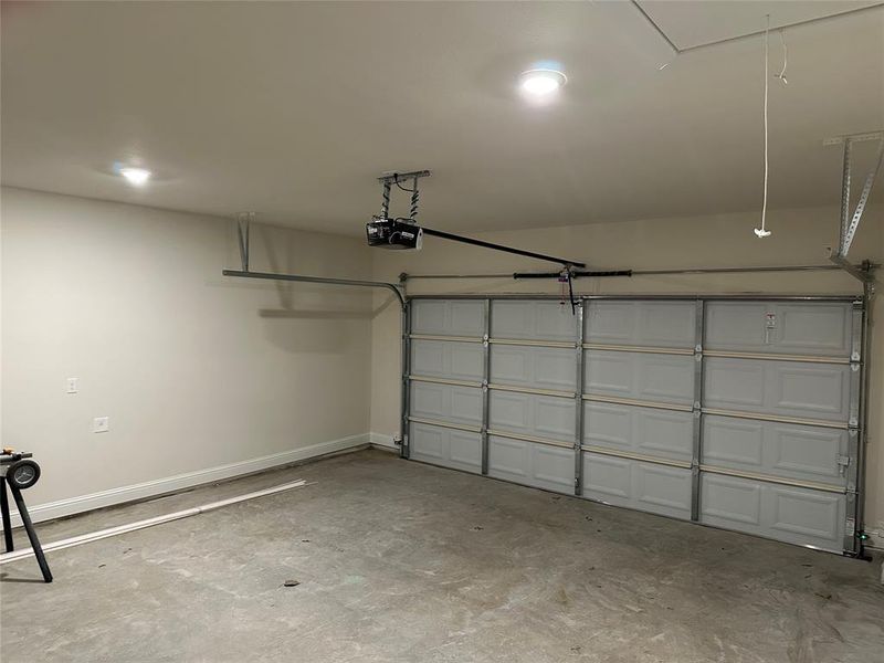 Two car garage with a garage door opener.