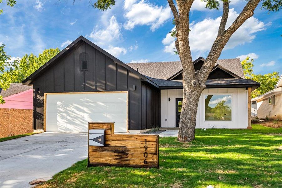 Modern farmhouse with a garage and a front yard