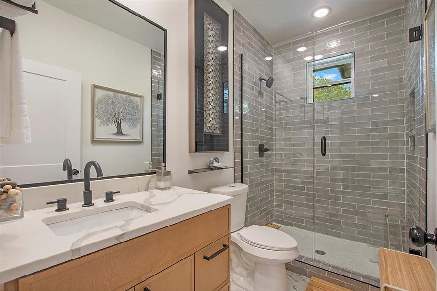 Bathroom with vanity and a stall shower Bathroom with vanity and a stall shower