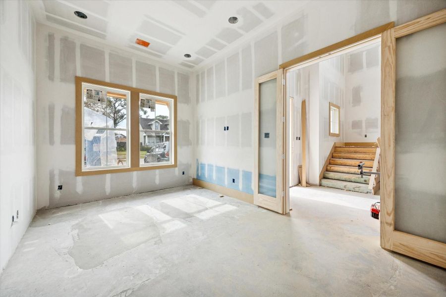 Positioned off the main entry, the study provides a calm, enclosed space ideal for a home office or library. Generous windows bring in soft natural light, while the layout allows for built ins, desk space, and comfortable seating without interrupting the flow of the surrounding living areas.