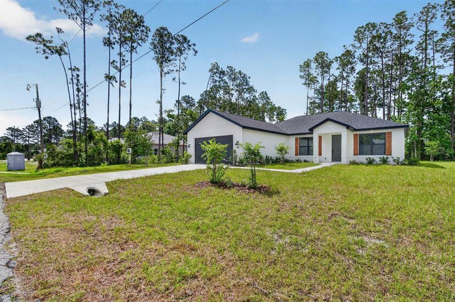 Front exterior of a new home in , Palm Coast, FL, highlighting curb appeal (Image 23). Front exterior of a new home in , Palm Coast, FL, highlighting curb appeal (Image 23).
