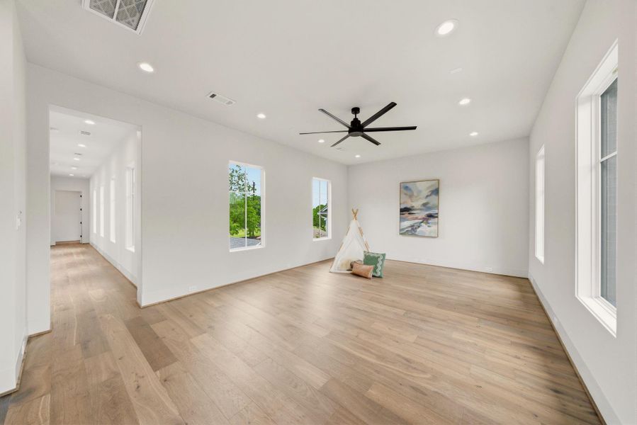 Bright secondary living space with soaring ceilings, oversized windows, and a relaxed modern aesthetic.