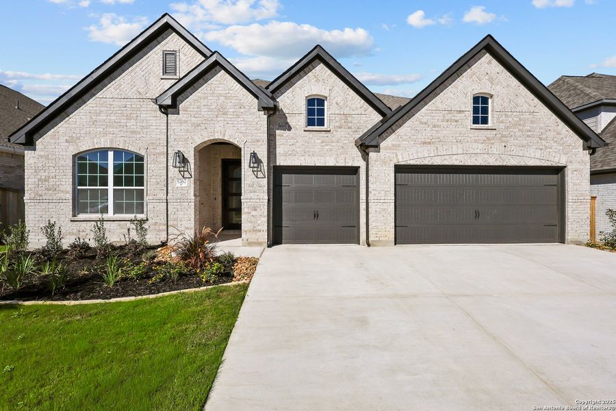 Front exterior of a new home in Mayfair 60', New Braunfels, TX, highlighting curb appeal (Image 25).