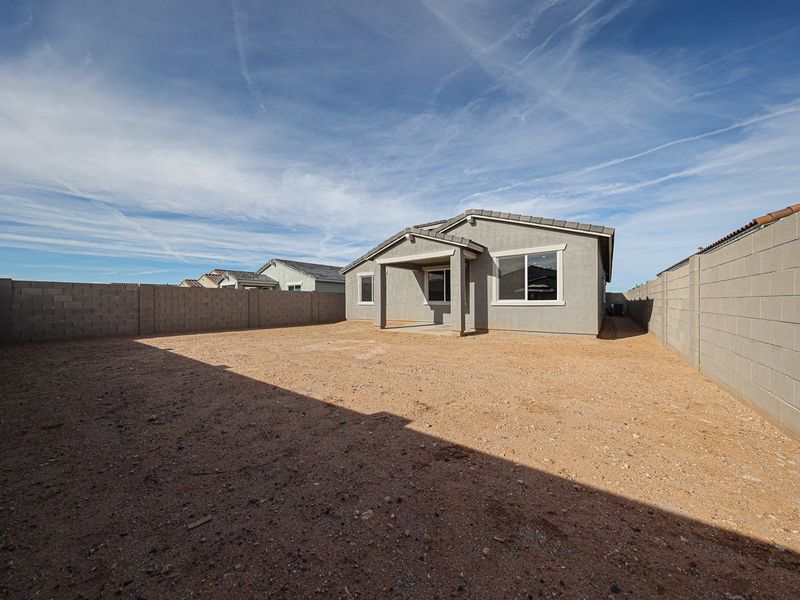 A dirt area with buildings in the background. A dirt area with buildings in the background.