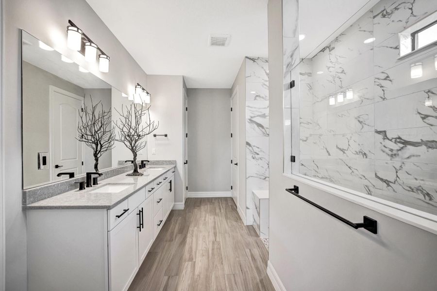 Primary bathroom with large walk-in shower, dual sinks, linen closet and dedicated water closet