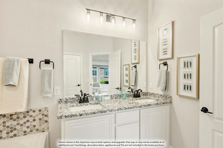 Bathroom with double sink vanity, white cabinets, granite countertops, and large mirror with overhead lighting Bathroom with double sink vanity, white cabinets, granite countertops, and large mirror with overhead lighting