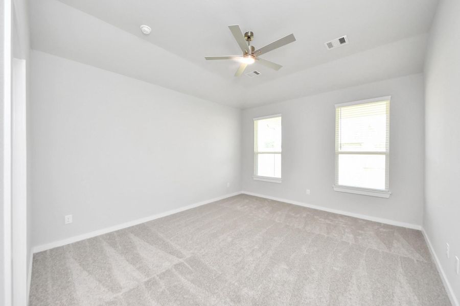 Come and unwind after a long day in this magnificent primary suite! This spacious room features plush carpet, warm paint, high ceilings and large windows with privacy blinds. Come and unwind after a long day in this magnificent primary suite! This spacious room features plush carpet, warm paint, high ceilings and large windows with privacy blinds.