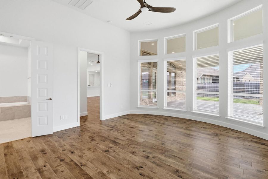 Primary bedroom is a true oasis with en suite bath and floor to ceiling windows adding natural light and views of the backyard.