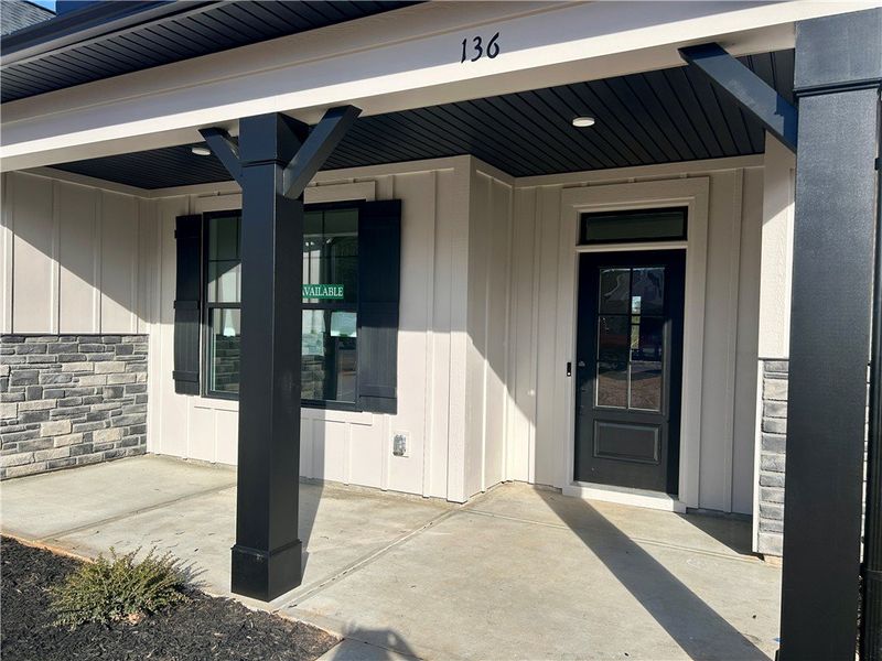 This inviting entrance features a covered porch, w