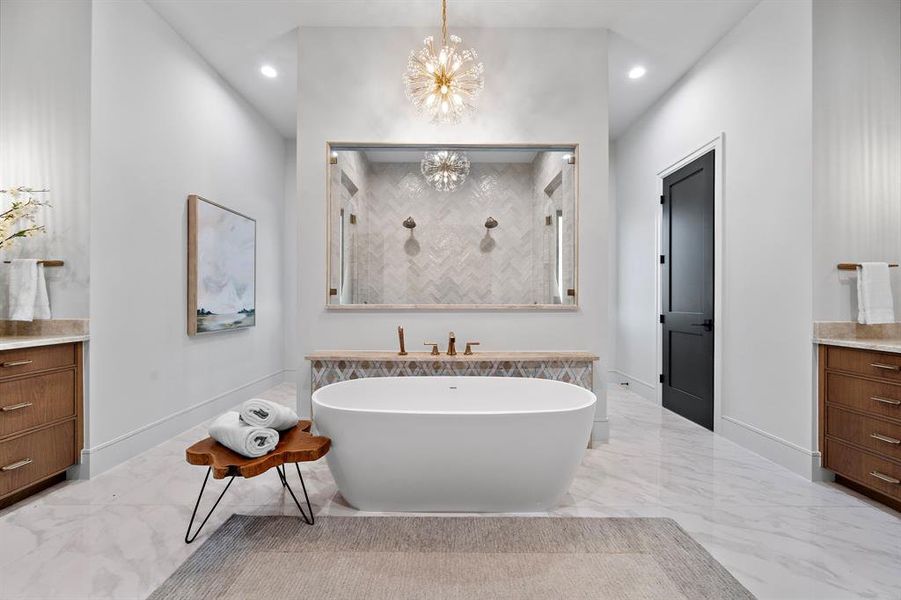 In the primary bath, the double shower is just beyond the free-standing tub.   Upgraded fixtures are found throughout the home.