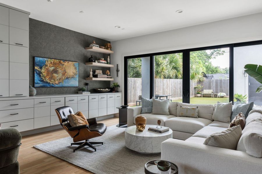 The family room is filled with natural light and opens to the patio through large sliding glass doors, creating an easy indoor outdoor flow for everyday living and hosting.