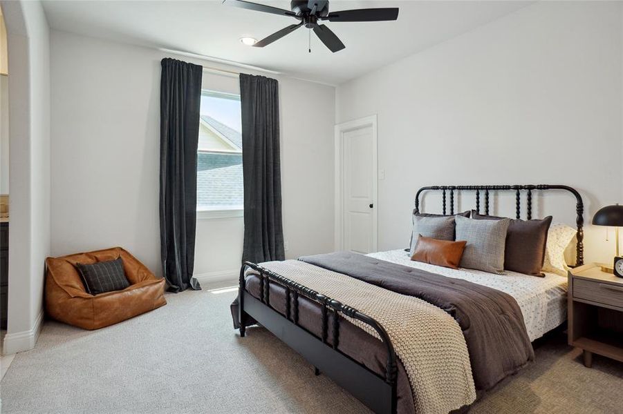 Carpeted bedroom with ceiling fan