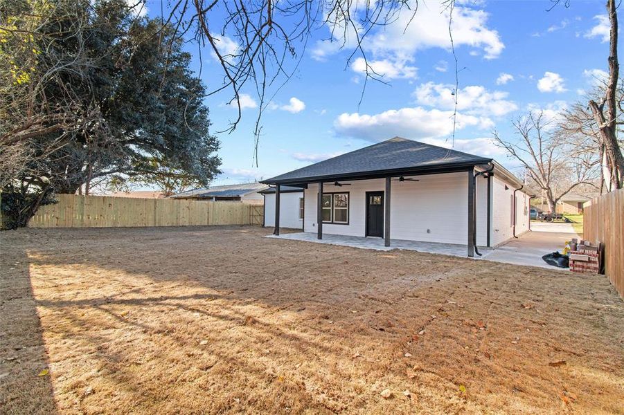 Back of house featuring a yard, a patio, and ceiling fan