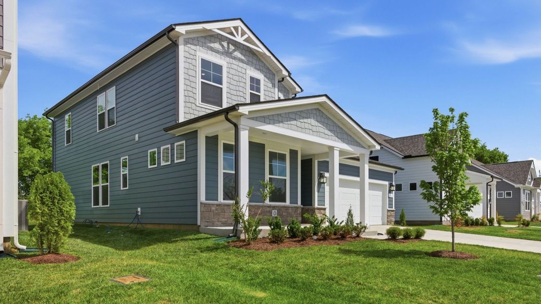 Home exterior with blue siding and two car garage Home exterior with blue siding and two car garage